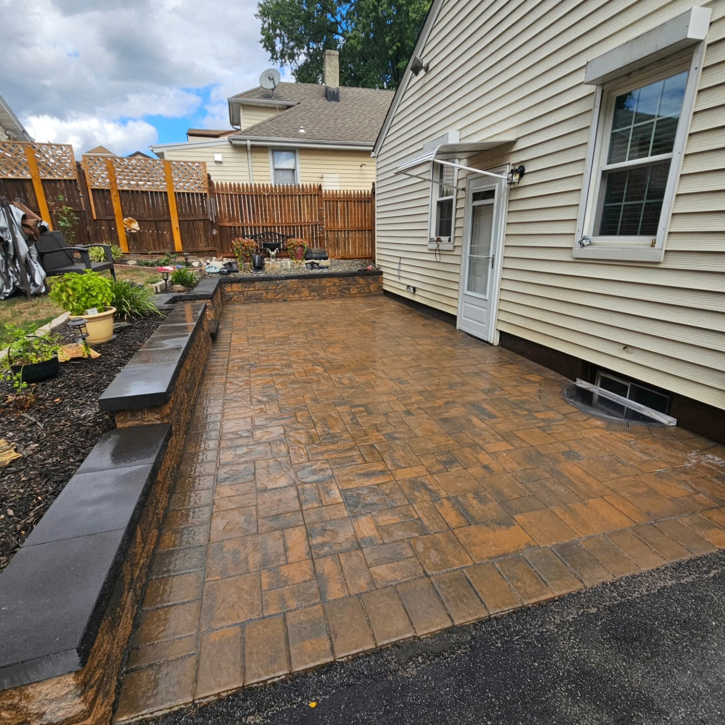 Stamped patio and raised wall detail beside a home